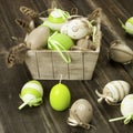 Easter eggs in the vintage box on rustic wooden surface