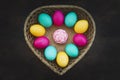 Colorful Easter eggs in a weaved basket on black background. concept of the celebration of Easter Sunday in the Christian Royalty Free Stock Photo