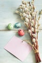 Easter eggs, willow twigs and blank paper card background Royalty Free Stock Photo