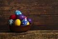 Easter eggs on wooden background. Easter eggs in the basket of wooden boards Royalty Free Stock Photo