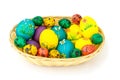 Easter eggs in a wooden basket, beautifully decorated eggs isolated