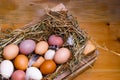 Easter eggs in wooden box, in nest from straw on wooden background Royalty Free Stock Photo