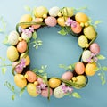 Easter eggs wreath on light blue background