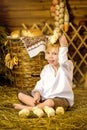 Easter fairy tale, a boy with chickens playing in a barn. Royalty Free Stock Photo