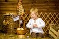 Easter fairy tale, a boy with chickens playing in a barn. Royalty Free Stock Photo