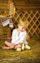 Easter fairy tale, a boy with chickens playing in a barn. Royalty Free Stock Photo