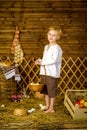 Easter fairy tale, a boy with chickens playing in a barn. Royalty Free Stock Photo