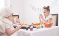 Easter in the family circle: Children at the table paint Easter eggs.