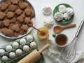 Easter festive background with eggs, cookies, marshmallows, tea with honey