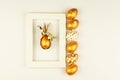 Easter festive decoration. Top view of easter eggs colored with golden paint and empty mock-up photo frame. Various dotted designs