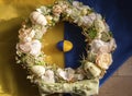 Easter festive decorative wreath lies on the Ukrainian flag and an egg painted in yellow and blue colors Royalty Free Stock Photo