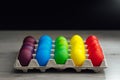 Easter festive multicolor eggs carton, black background Royalty Free Stock Photo