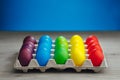 Easter festive multicolor eggs carton, blue background Royalty Free Stock Photo