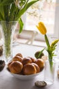 Easter festive spring table setting decoration, eggs in nest, fresh yellow tulips, marshmallows, selective focus Royalty Free Stock Photo