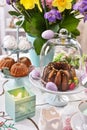 Easter festive table decoration with spring flowers and pastries