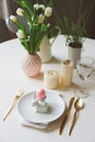 Easter festive table details. Dining place decorated in pink and gold tones