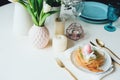 easter festive table details. Dining place decorated in trendy scandinavian style, pink and gold tones