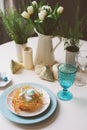 Easter festive table with dining place decorated with nest