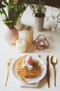 Easter festive table with dining place decorated with nest