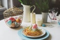 Easter festive table with dining place decorated with nest