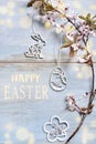 Easter flat lay with blooming branch and cut-out decors