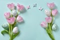 Easter flat lay with pink tulips and eggs on mint background