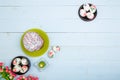 Easter flatlay composition with decorated eggs, flowers, burning candle and Easter bread or cake with glaze and multicolored sugar