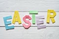Easter folded paper origami colorful lettering on white wooden planks rustic background