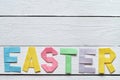 Easter folded paper origami colorful lettering on white wooden planks rustic background