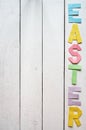 Easter folded paper origami colorful lettering on white wooden planks rustic background