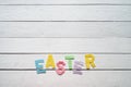 Easter folded paper origami colorful lettering on white wooden planks rustic background