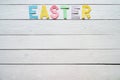 Easter folded paper origami colorful lettering on white wooden planks rustic background