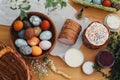 Easter food flat lay. Easter eggs natural dyed, easter bread, ham, beets, butter, green branches  and flowers on rustic wooden Royalty Free Stock Photo