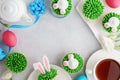 Easter background with bunny cupcakes, tea and painted eggs Royalty Free Stock Photo