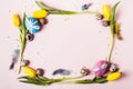 Easter Frame of beautiful yellow tulips, decorated eggs and beads. Holiday mock up Royalty Free Stock Photo