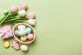 Easter frame with eggs, gift box and tulip on a colored background. The minimal concept. Top view Happy Easter Royalty Free Stock Photo