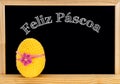 Easter frame with painted eggs and chalkboard. Happy Easter in white chalk. Happy Easter in portuguese : feliz pÃÂ¡scoa