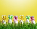 Easter funny bunny on green grass with easter eggs. Easter background.