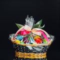 Easter gift basket with multicolor eggs, black background