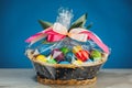 Easter gift basket with multicolor eggs, blue background