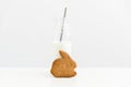 Easter gingerbread bunny shape with bottle of milk. Minimalist Easter. White background. Happy Easter card