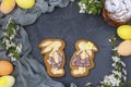 Easter gingerbread in the form of cute rabbits are located on a dark background, Concept of the spring church holiday Royalty Free Stock Photo