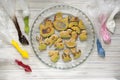 Easter gingerbreads in baking bowl, coloring material made from egg and sugar white in plastic bags, green, brown, yellow, red, wh