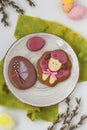 Easter gingerbreads in the form of cute sheep and eggs in a plate on white background, The concept of the spring church holiday