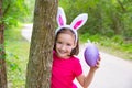 Easter girl with big purple egg and funny bunny ears