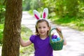 Easter girl with eggs basket and funny bunny ears