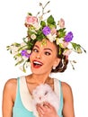 Easter girl holding bunny. Woman with holiday spring flowers hairstyle.