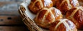 Easter. Good Friday. Homemade hot cross buns in a basket on a wooden table