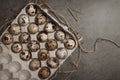 Easter gray background with a in cardboard packaging of quail eggs. Top view. Copy space.