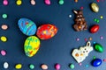 Easter greeting card with colorful candy frame and Easter egg, chocolate bunny and eggs Royalty Free Stock Photo